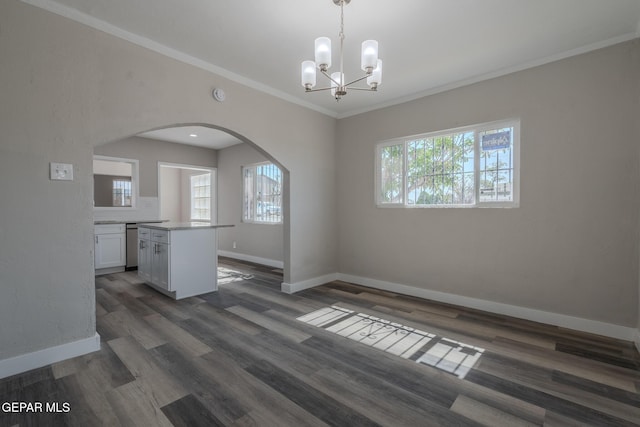 3427 Hamilton Ave, El Paso, TX 79930 - unfurnished dining area with arched walkways, baseboards, ornamental molding, a chandelier, and dark wood finished floors