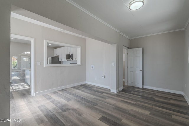 3427 Hamilton Ave, El Paso, TX 79930 - spare room featuring dark wood-style floors, crown molding, and baseboards