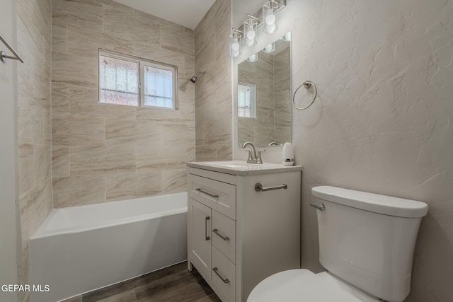 3427 Hamilton Ave, El Paso, TX 79930 - full bathroom featuring vanity, toilet, bathtub / shower combination, and wood finished floors