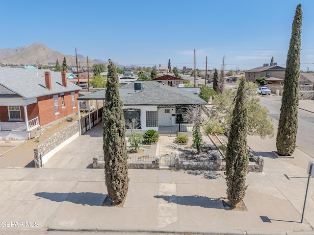 3427 Hamilton Ave, El Paso, TX 79930 - view of front of house with a fenced front yard, driveway, a carport, and a mountain view