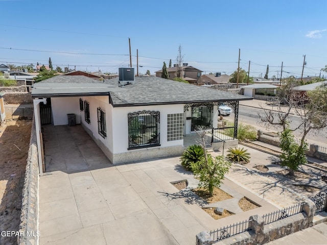 3427 Hamilton Ave, El Paso, TX 79930 - back of house featuring central air condition unit, stucco siding, and roof with shingles