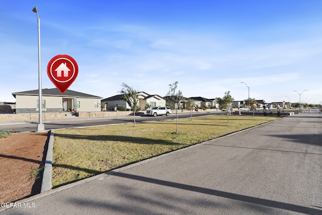 2528 Mike Price Dr, El Paso, TX 79938 - view of asphalt street with a residential view and street lights