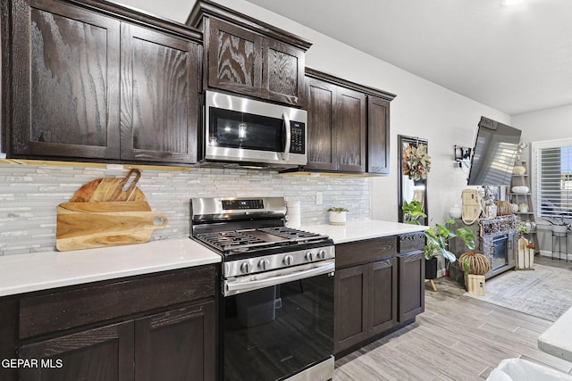 2528 Mike Price Dr, El Paso, TX 79938 - kitchen featuring stainless steel appliances, dark brown cabinets, light countertops, and light wood-style floors