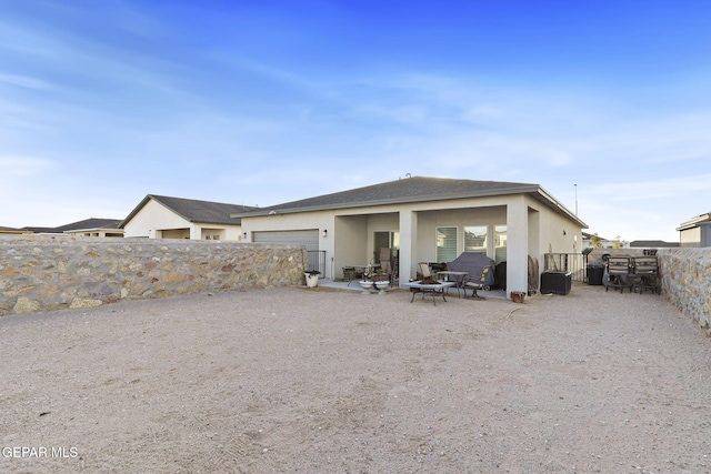 2528 Mike Price Dr, El Paso, TX 79938 - rear view of property featuring stucco siding and a garage