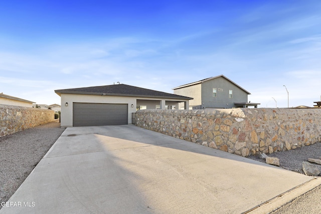 2528 Mike Price Dr, El Paso, TX 79938 - view of front of home with stucco siding, concrete driveway, and a garage