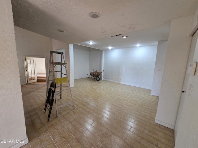 441 Irondale Dr, El Paso, TX 79912 - basement with a textured ceiling, baseboards, and wood finished floors