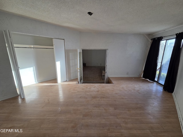 441 Irondale Dr, El Paso, TX 79912 - unfurnished living room featuring a textured ceiling and wood finished floors