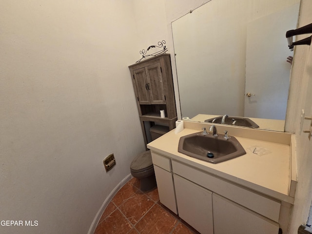441 Irondale Dr, El Paso, TX 79912 - bathroom with vanity, toilet, stone finish flooring, and baseboards