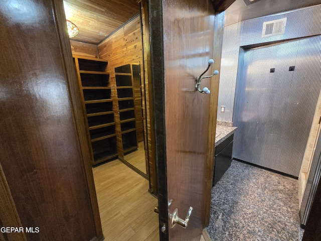 441 Irondale Dr, El Paso, TX 79912 - bathroom with vanity, wood finished floors, wood walls, and wood ceiling