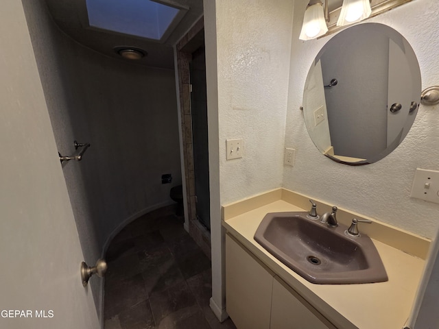 441 Irondale Dr, El Paso, TX 79912 - bathroom with vanity, a shower, and a textured wall