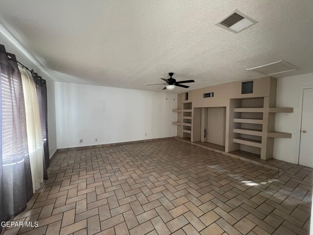 3208 Lampliter Pl, El Paso, TX 79925 - unfurnished living room featuring a ceiling fan, a textured ceiling, and attic access