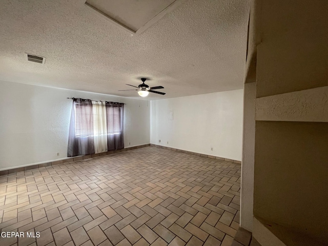 3208 Lampliter Pl, El Paso, TX 79925 - empty room with a textured ceiling, brick patterned floors, baseboards, and a ceiling fan