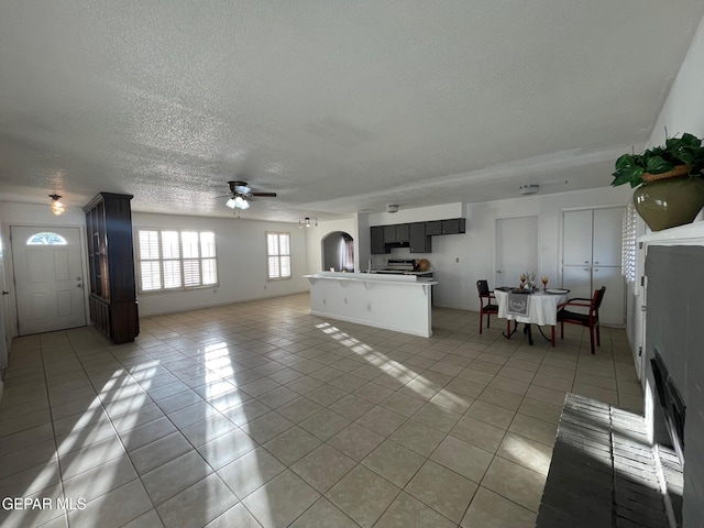 3208 Lampliter Pl, El Paso, TX 79925 - living room featuring light tile patterned floors, a textured ceiling, and a ceiling fan
