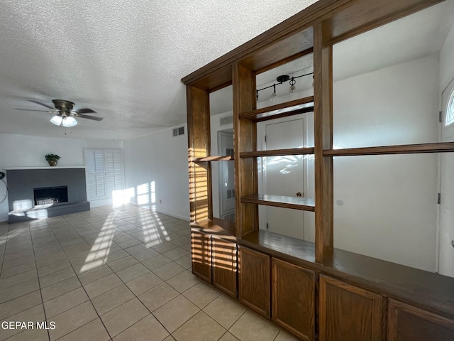 3208 Lampliter Pl, El Paso, TX 79925 - hallway with light tile patterned floors, a textured ceiling, and baseboards