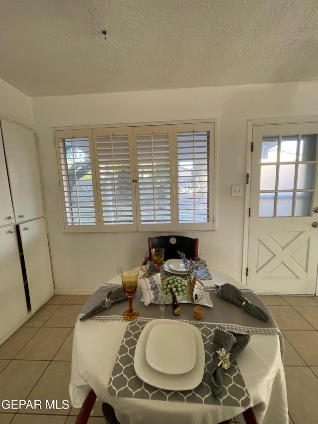3208 Lampliter Pl, El Paso, TX 79925 - dining room with light tile patterned floors, plenty of natural light, and a textured ceiling