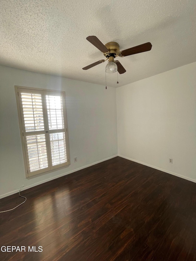 3208 Lampliter Pl, El Paso, TX 79925 - empty room with dark wood-type flooring, a textured ceiling, a ceiling fan, and baseboards