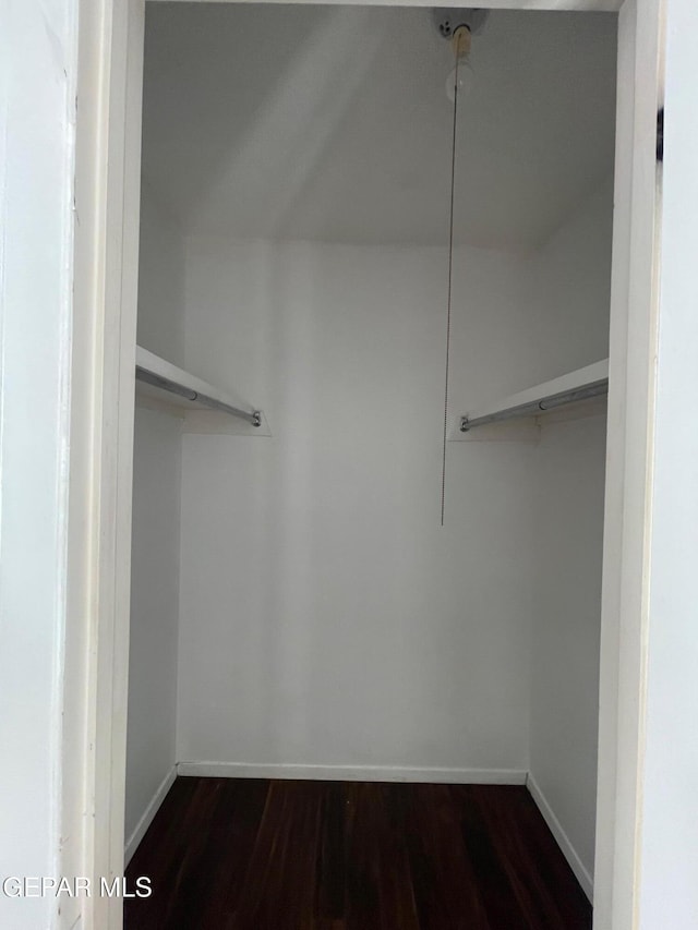 3208 Lampliter Pl, El Paso, TX 79925 - spacious closet featuring dark wood-type flooring