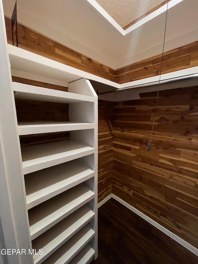 3208 Lampliter Pl, El Paso, TX 79925 - walk in closet with dark wood-type flooring