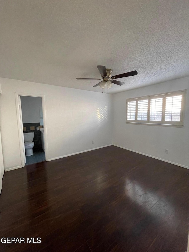 3208 Lampliter Pl, El Paso, TX 79925 - spare room featuring ceiling fan, dark wood-style floors, baseboards, and a textured ceiling