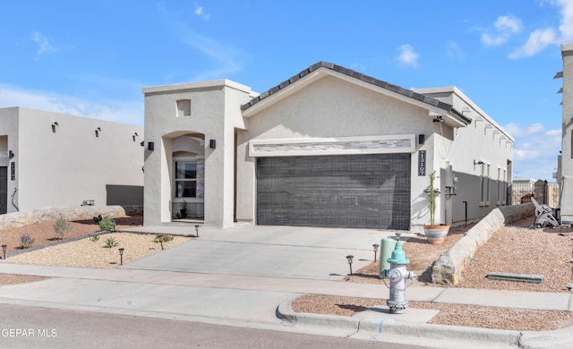 13107 Kington Ave, El Paso, TX 79928 - view of front of property with a garage, concrete driveway, and stucco siding