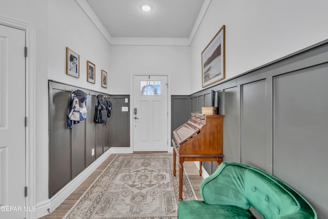 13107 Kington Ave, El Paso, TX 79928 - foyer entrance featuring light wood finished floors, a decorative wall, wainscoting, and ornamental molding