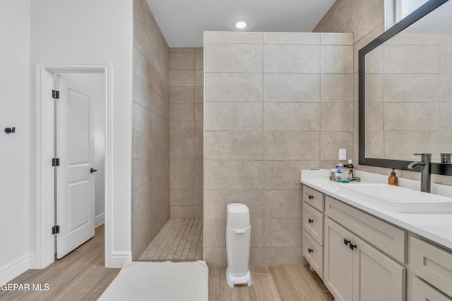 13107 Kington Ave, El Paso, TX 79928 - full bath with wood finished floors, vanity, a walk in shower, and tile walls