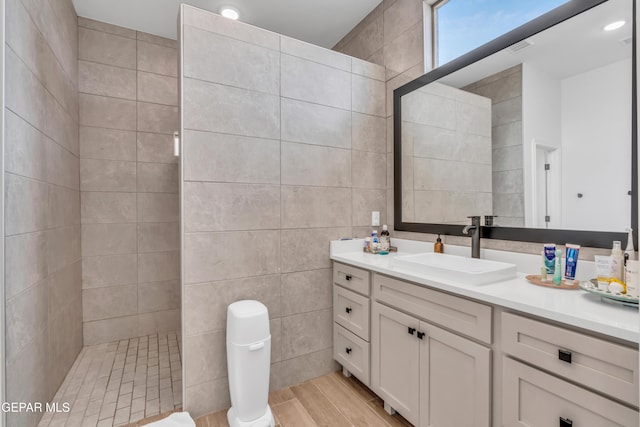 13107 Kington Ave, El Paso, TX 79928 - bathroom with vanity, a walk in shower, wood finished floors, tile walls, and toilet