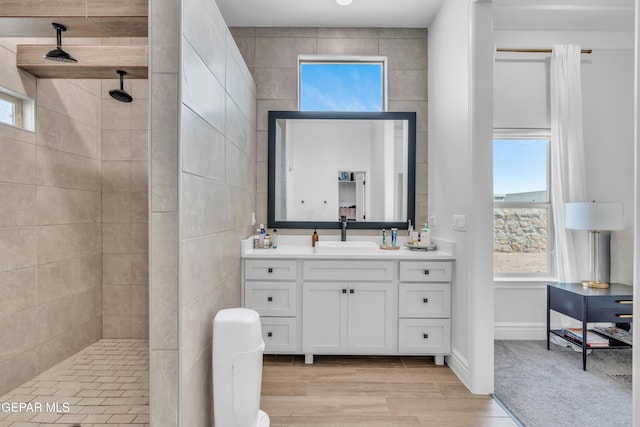 13107 Kington Ave, El Paso, TX 79928 - bathroom featuring tiled shower, vanity, and wood finished floors