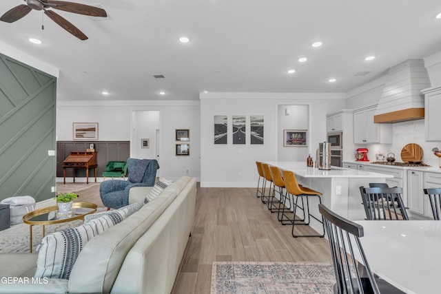 13107 Kington Ave, El Paso, TX 79928 - living room with ceiling fan, recessed lighting, light wood-type flooring, ornamental molding, and baseboards