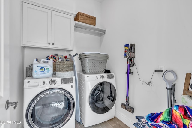 13107 Kington Ave, El Paso, TX 79928 - laundry area featuring washer and clothes dryer, cabinet space, wood finished floors, and baseboards