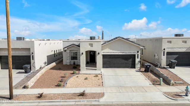 13107 Kington Ave, El Paso, TX 79928 - adobe home featuring stucco siding, a garage, and driveway