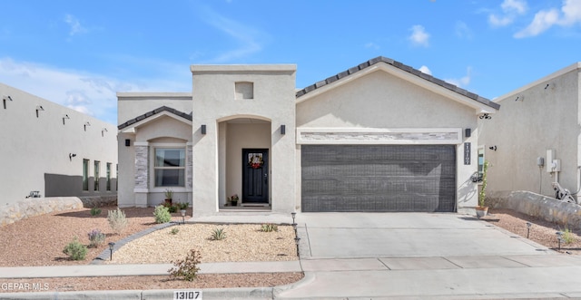 13107 Kington Ave, El Paso, TX 79928 - mediterranean / spanish home with an attached garage, concrete driveway, and stucco siding