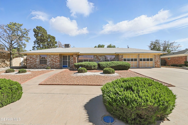 9204 Rex Ct, El Paso, TX 79925 - single story home with concrete driveway, a garage, and brick siding