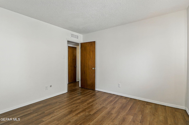 9204 Rex Ct, El Paso, TX 79925 - spare room with dark wood-style floors, baseboards, and a textured ceiling