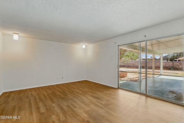 9204 Rex Ct, El Paso, TX 79925 - empty room featuring wood finished floors, baseboards, and a textured ceiling