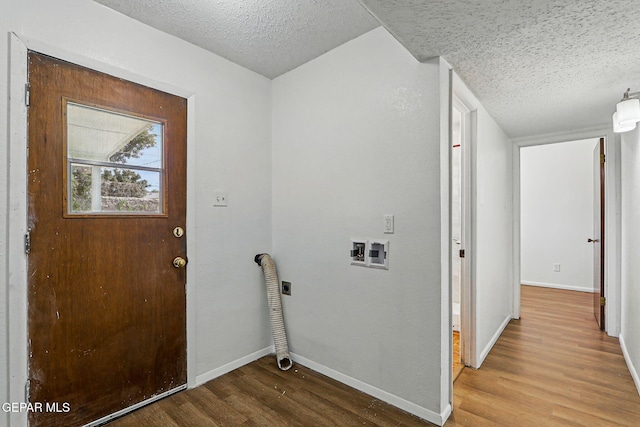 9204 Rex Ct, El Paso, TX 79925 - laundry room featuring hookup for an electric dryer, a textured ceiling, wood finished floors, hookup for a washing machine, and baseboards