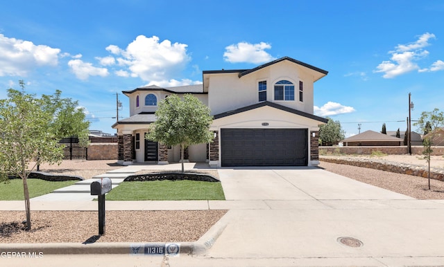 11316 Menlo Ave, El Paso, TX 79936 - view of front facade with a garage, driveway, stucco siding, and stone siding