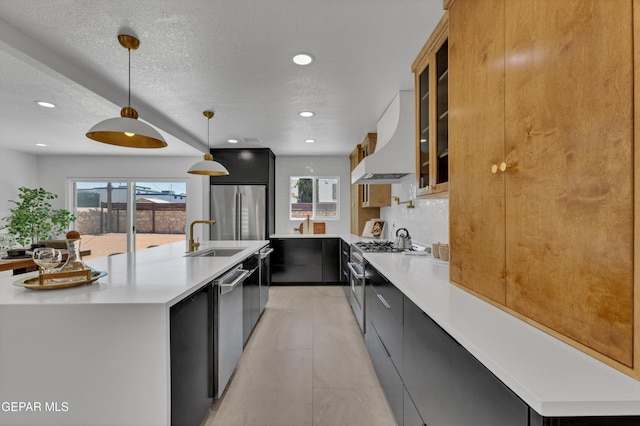 11316 Menlo Ave, El Paso, TX 79936 - kitchen with wall chimney exhaust hood, stainless steel appliances, a sink, a large island with sink, and recessed lighting