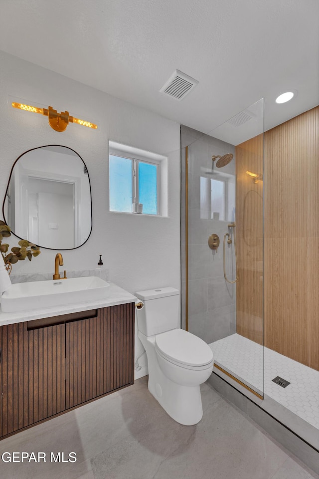 11316 Menlo Ave, El Paso, TX 79936 - bathroom with toilet, tiled shower, and vanity