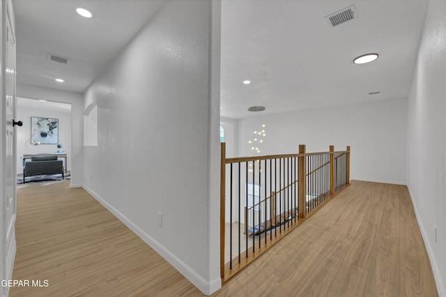 11316 Menlo Ave, El Paso, TX 79936 - hall featuring light wood-type flooring, an upstairs landing, recessed lighting, and baseboards