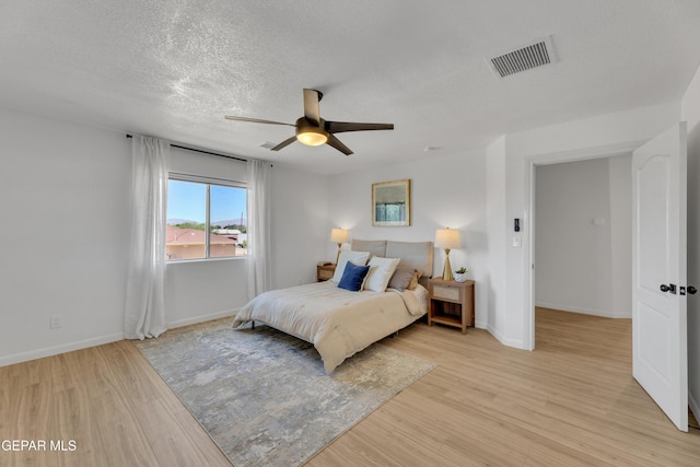 11316 Menlo Ave, El Paso, TX 79936 - bedroom featuring light wood-type flooring, a textured ceiling, baseboards, and ceiling fan