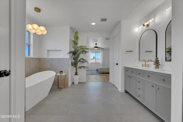 11316 Menlo Ave, El Paso, TX 79936 - ensuite bathroom with vanity, a freestanding bath, and a ceiling fan