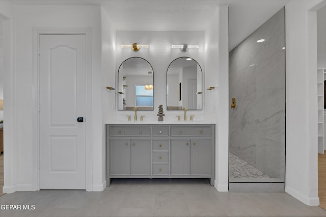 11316 Menlo Ave, El Paso, TX 79936 - bathroom with a marble finish shower, double vanity, baseboards, and a closet