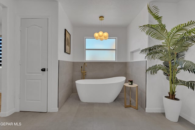 11316 Menlo Ave, El Paso, TX 79936 - bathroom with a soaking tub, tile walls, wainscoting, and tile patterned flooring
