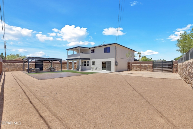 11316 Menlo Ave, El Paso, TX 79936 - rear view of house featuring a patio, a fenced backyard, stucco siding, a pergola, and a balcony
