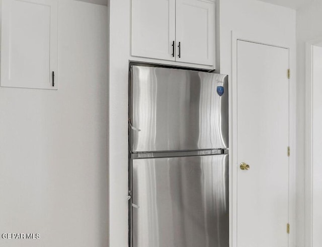 1117 Zuni Pl, El Paso, TX 79925 - kitchen featuring freestanding refrigerator and white cabinets