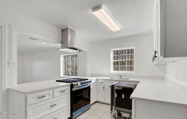 1117 Zuni Pl, El Paso, TX 79925 - kitchen with stainless steel range with gas stovetop, island range hood, a sink, white cabinetry, and light countertops