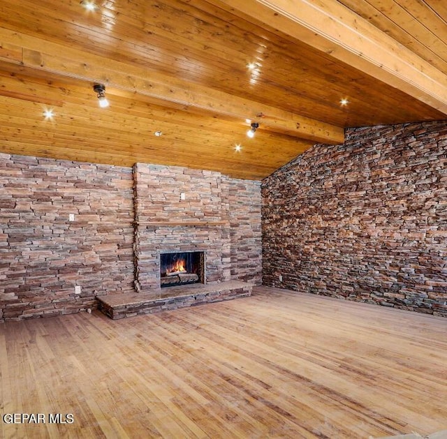 1117 Zuni Pl, El Paso, TX 79925 - unfurnished living room featuring wood finished floors, a stone fireplace, and wooden ceiling with exposed beams