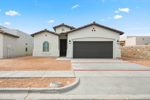 13832 Paseo Bosque Ave, El Paso, TX 79928 - mediterranean / spanish home with an attached garage, driveway, stucco siding, and a tile roof