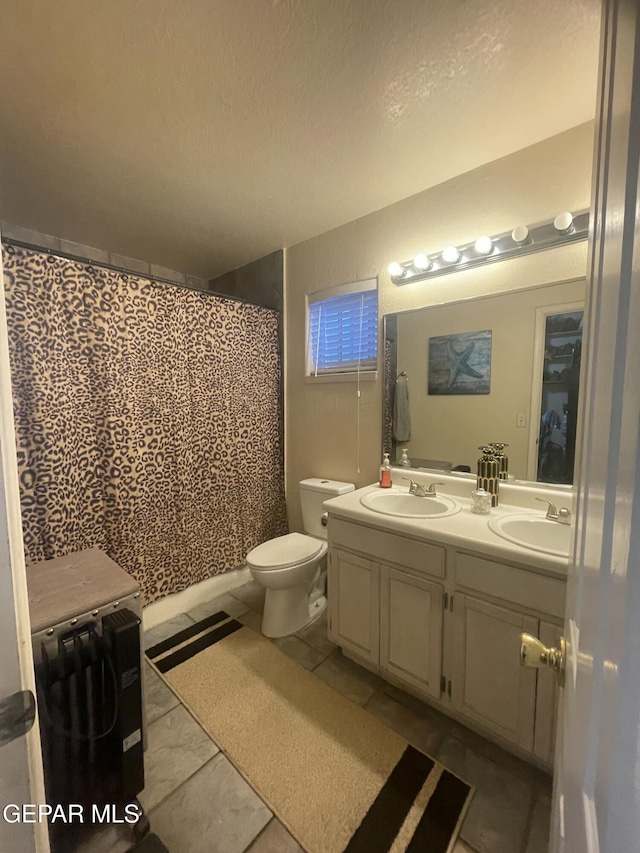 1360 Luz Carpio Way, El Paso, TX 79936 - full bath featuring double vanity, toilet, and a textured ceiling